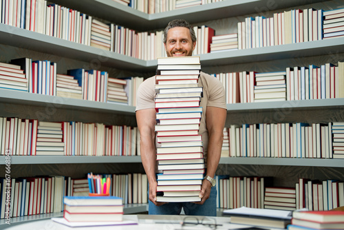 Teachers gay. Funny teacher hold many books at school. Crazy teacher with books in school. Excited teacher in school book library. School teacher.