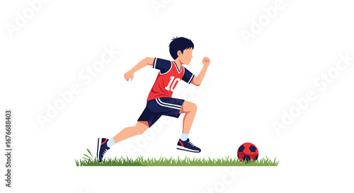 Young boy athlete running with soccer ball on green grass field during daytime