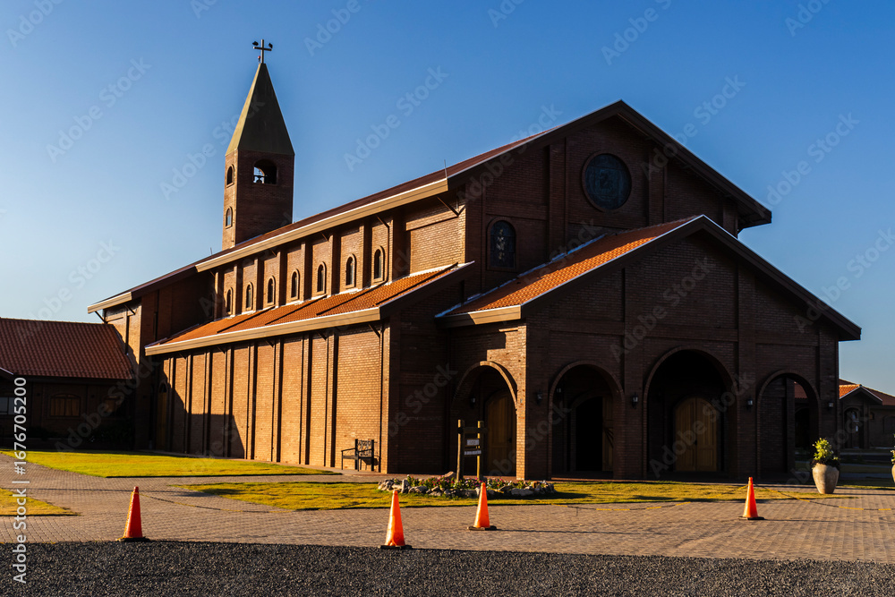 Fototapeta premium Facade of the church built with bricks in view of the Divina Misericordia Monastery, in rural area of ​​the Marilia, Sao Paulo state, Brazil