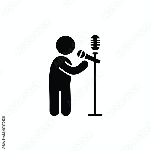 A person singing into a microphone on a stand, performing on stage.