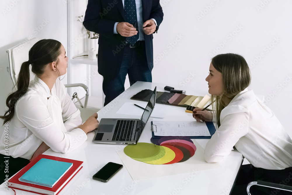 Fototapeta premium Group brainstorming session in a modern office with creatives discussing project details