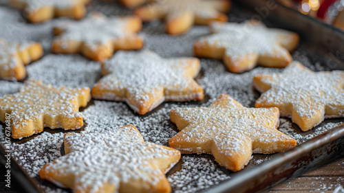 Homemade gingerbread cookies shaped like snowflakes adorn a baking sheet. Powdered sugar dusting adds a wintry touch, perfect for holiday celebrations and family gatherings.generative ai