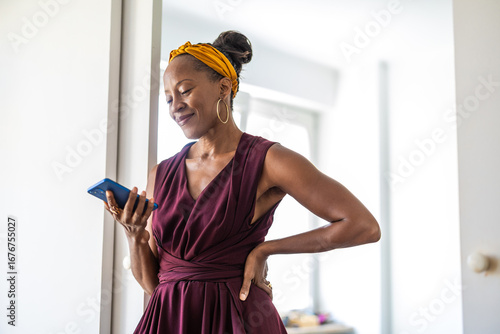 Portrait of smiling businesswoman using mobile phone in office
