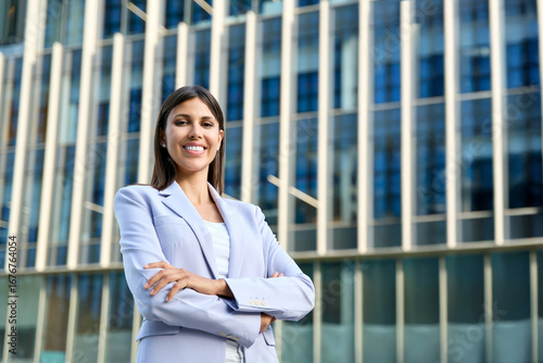 Free Download Beautiful hispanic business woman with crossed arms smiling at camera outside. European or latin confident mature good looking middle age leader female businesswoman at office building, copy space - GFXLoad