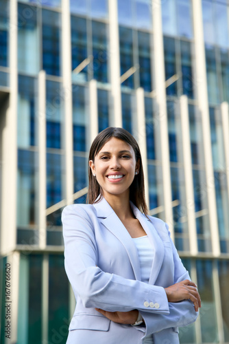 Free Download Vertical portrait of hispanic business woman with crossed arms smiling at camera outside. European or latin confident mature good looking middle age leader female businesswoman at office building - GFXLoad