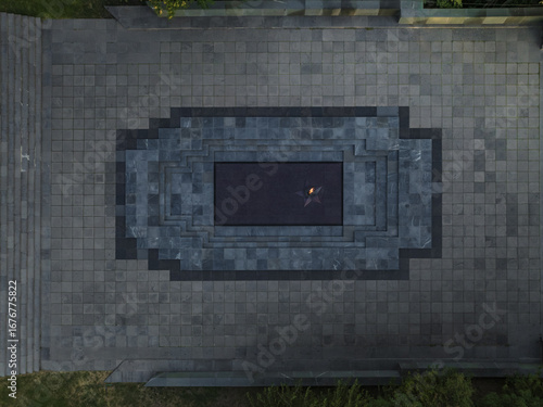 Aerial view of the eternal flame flickering against the dark stone of the Armenian Genocide memorial complex, Yerevan, Yerevan, Armenia.