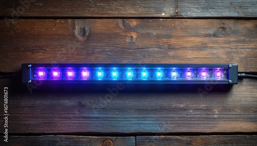 LED light bar on rustic wood.  Multicolored LEDs in a horizontal row
