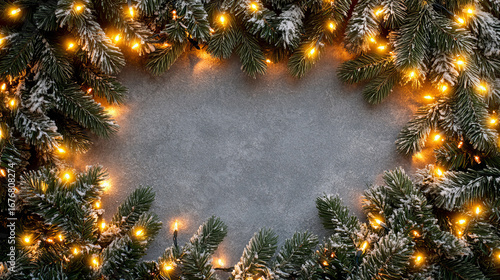Frosted Christmas pine branches with glowing golden fairy lights on a textured stone background, festive winter holiday frame design for seasonal celebration, New Year greeting