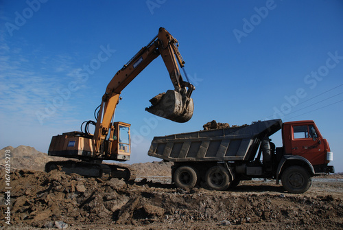 Wallpaper Mural Heavy construction machines actively working on a building site. Excavators, bulldozers, and other equipment move soil and materials, symbolizing progress, development, and modern infrastructure. Torontodigital.ca