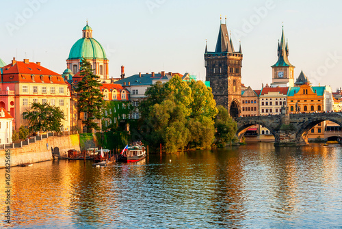 Charles Bridge over Vltava river and architecture of the Old Town in Prague, Czech republic. Pleasure ship on the Vltava river in Prague. Charles Bridge the main attraction of Prague in Czech republic