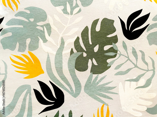 Tropical fabric pattern with abstract green monstera leaves, yellow and black accents on light background. Modern botanical textile design for fashion, home decor, summer style, and creative projects.
