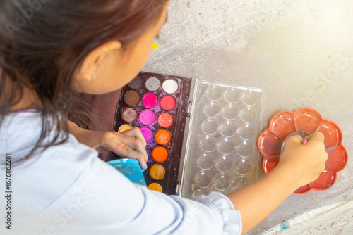Asian kid child little girl painting craft with colourful watercolor, creativity activity concept