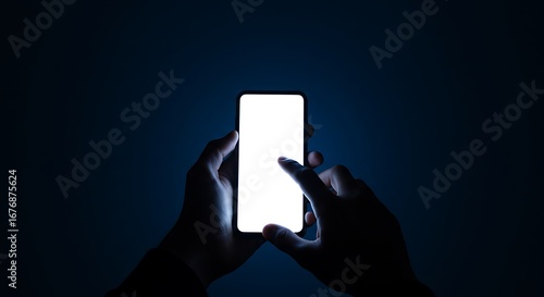 A person's hands holding and interacting with a glowing smartphone screen against a dark background.