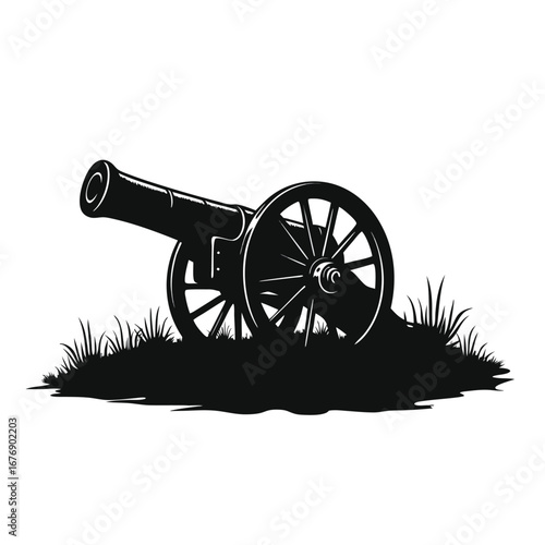 Black silhouette of an antique cannon on grassy ground