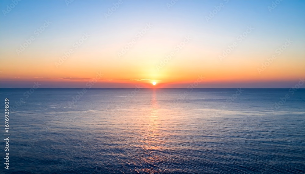 Fototapeta premium Serene ocean sunset with vibrant colors reflecting on the calm water.