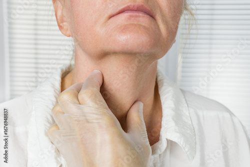 Doctor exames the thyroid gland in a patient of an adult woman, thyroid cancer