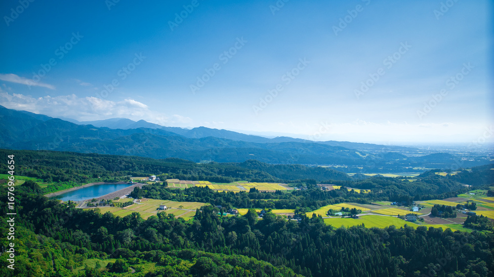 Obraz premium View of Toyama Bay, the Kurobe River alluvial fan, the Hokuriku Shinkansen, and farms from Kurobe City in eastern Toyama Prefecture, Japan