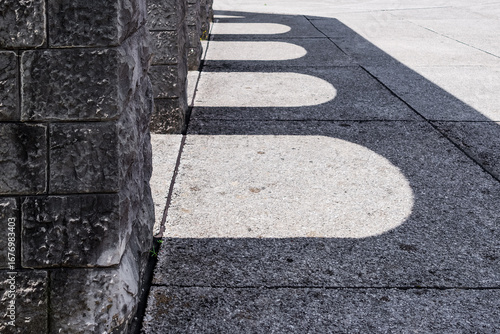 Fototapeta stone arches shadows on textured concrete floor