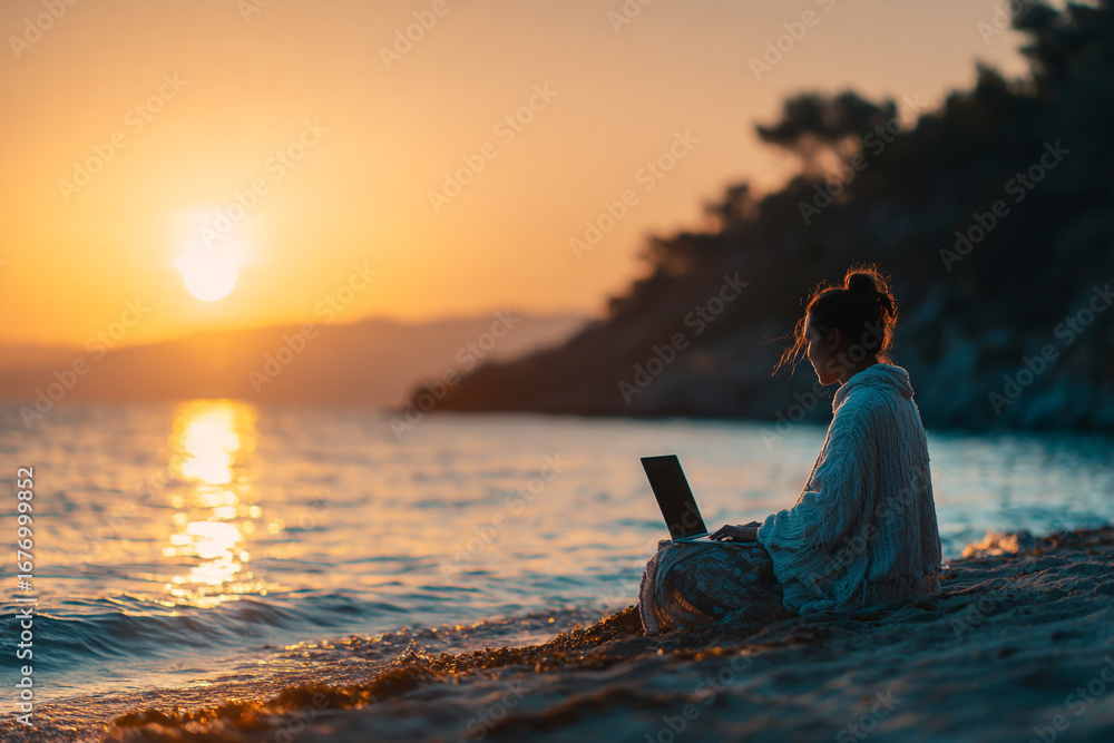 Fototapeta premium High-resolution image of a person using a laptop on a sandy beach, ideal for freelancing, travel, or tech lifestyle visuals.