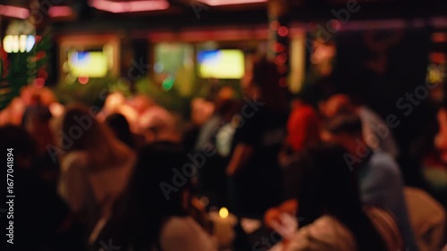 Wallpaper Mural The blurred background highlights a lively bar scene with patrons interacting and enjoying themselves Torontodigital.ca