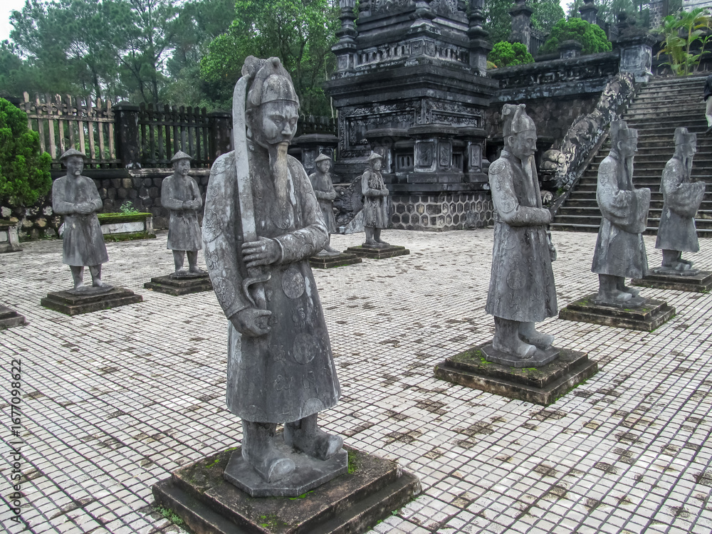 Obraz premium Hue, Vietnam. Row of statues at Minh Mang Tomb, Hue, Vietnam. Stone statues of the army in the mausoleum of Vietnam emperor ancient cultural heritage of Vietnam in province Hue