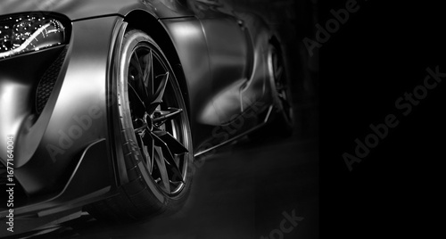 Front view of LED headlights sport car on black background