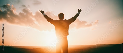 silhouette of a man at sunset with open arms