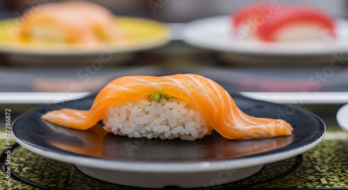 A Close Up of a Fresh Salmon Nigiri Sushi on a Black Plate