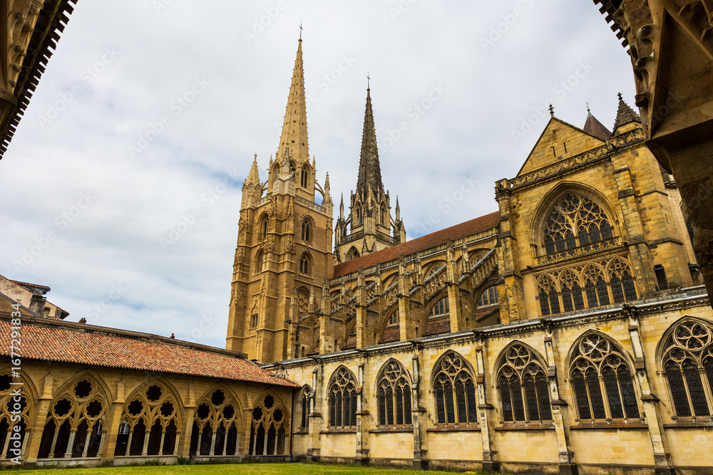 Fototapeta premium Cloister of Bayonne Cathedral Dominated by Its Two Gothic Spires