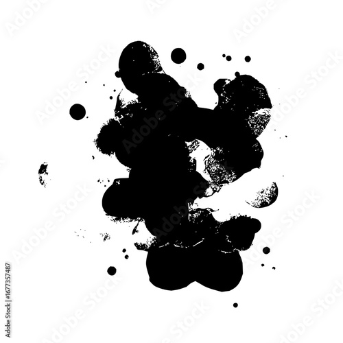 Black ink blotches and scattered droplets creating an abstract design on a white background surface view