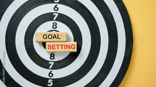 Target board with wooden blocks showing text Goal Setting, symbolizing achievement, motivation, business planning, strategy, career development, and personal success.