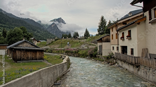 Mountain river in the village of Pralognon-La-Vanoise in the French Alps on a cloudy day 