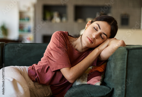 Konstfotografi Portrait of a  young woman sleeping napping on sofa and relaxing at home