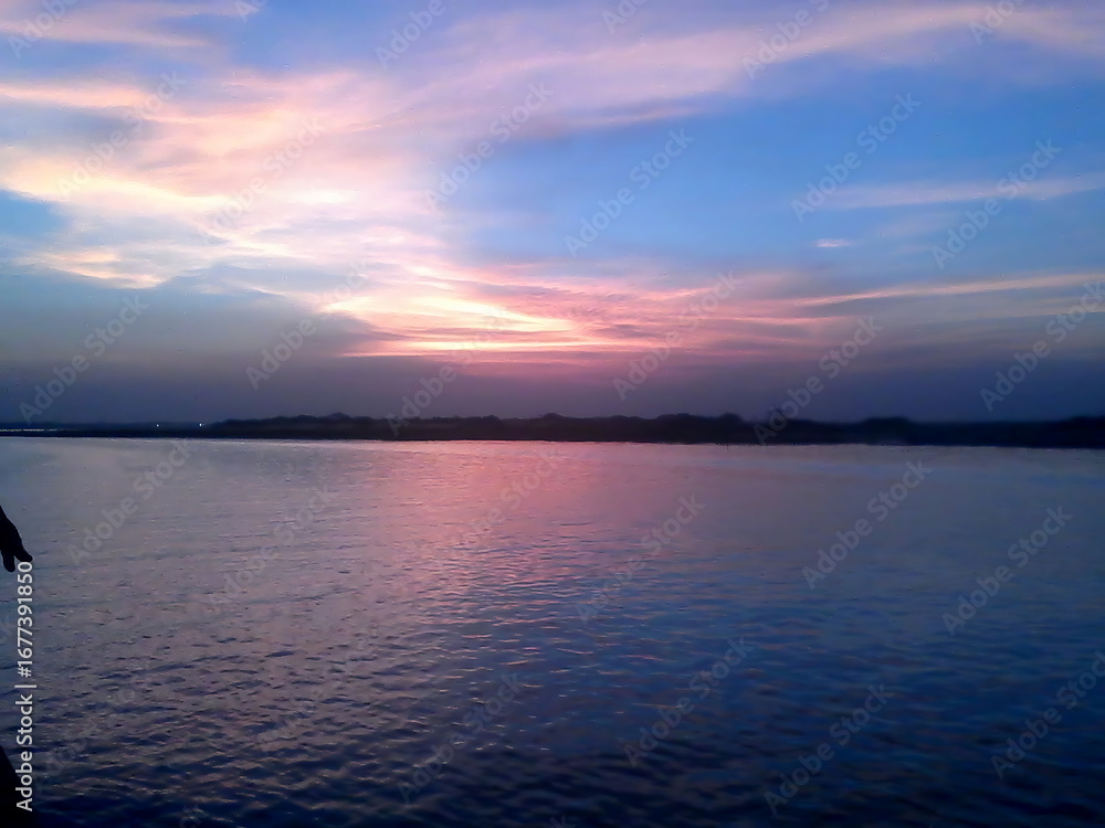 Fototapeta premium Beautiful sunset over river with colorful sky reflection