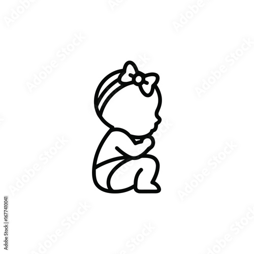 Photo of baby girl with a bow on her head, sitting and looking to the side
