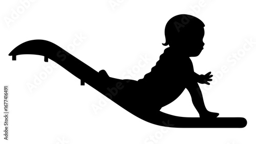Silhouette of Joy: A young child revels in the simple pleasure of play, silhouetted against the light as they embrace the joy of sliding, evoking a sense of innocent happiness.