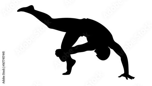Silhouette of Grace: A single person is captured mid-movement, in a moment of ballet, the photograph reveals the grace of movement and athleticism