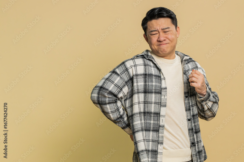 Φωτογραφία Asian middle-aged man suffering backache, massaging sore place lower spine, frowning from unbearable spasm torn muscles and tendons, kidney stones pinched nerve