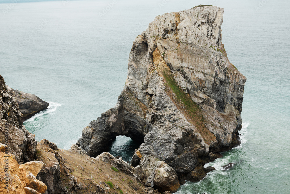 Naklejka premium Ursa Beach near Cabo da Roca in Portugal is a secluded wild beach with dramatic cliffs, unique rock formations, and Atlantic waves. High quality stock photo