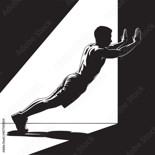 Silhouette of a man doing a wall push up exercise in a high contrast black and white setting indoors