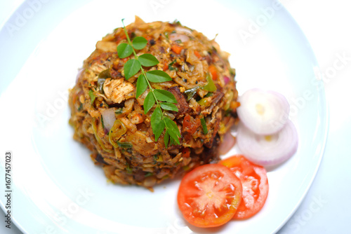 Chicken Kottu with Gravy Served on White Plate Close-Up. tomato, onion, curry leaves.
