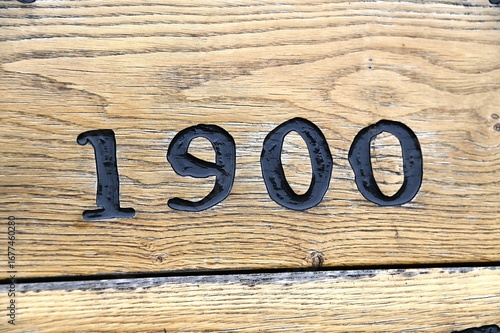 Year 1900 carved into the wood above a doorway of an old building in Denmark