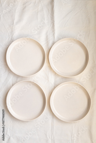 A set of handmade ceramic deep plates with a bowl like edge made from buff stoneware in a matt transparent glaze