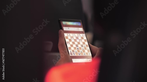 Man playing chess online using chess on phone