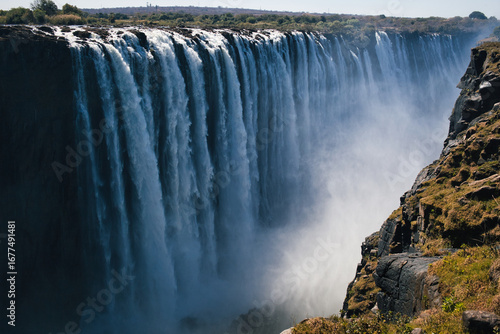 Witness the raw beauty of Victoria Falls, a stunning natural spectacle in Africa, with water cascading down.