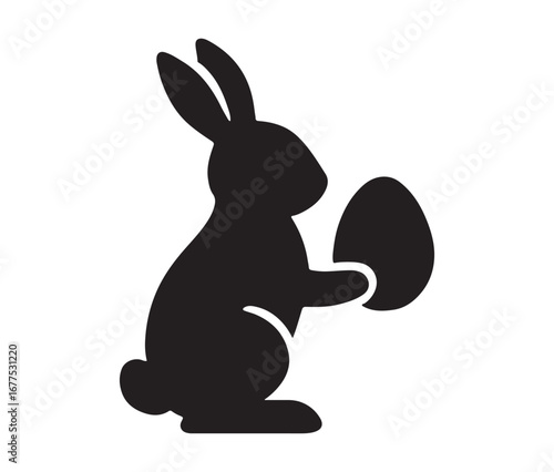 Black silhouette of a rabbit holding an easter egg festive spring celebration symbol