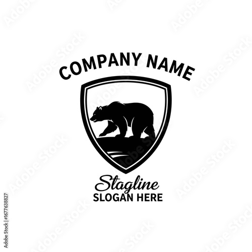 A black silhouette of a bear walking on a rocky shore with water in front of it, enclosed in a shield shape, with company name and tagline above and below.