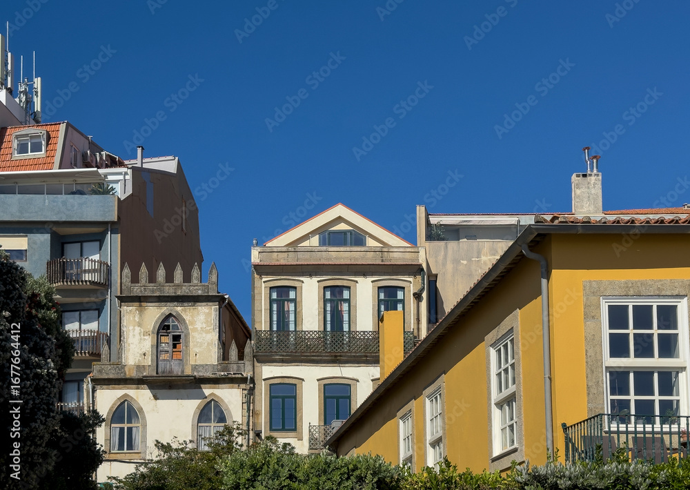 Fototapeta premium Colorful historic houses in Porto, Portugal, with traditional facades, balconies, and architectural