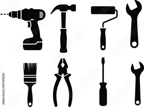 Set of black silhouette hand tools including cordless drill, hammer, paint roller, wrench, paintbrush, pliers, screwdriver, and adjustable wrench on white background