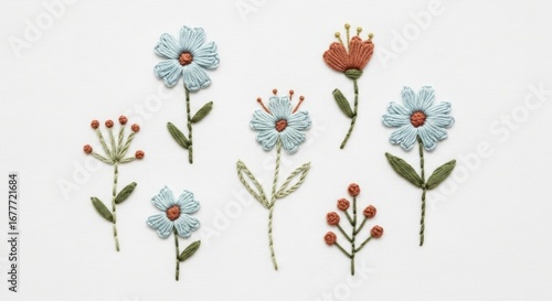 Handmade Embroidered Flowers in Blue and Orange on White Textured Fabric